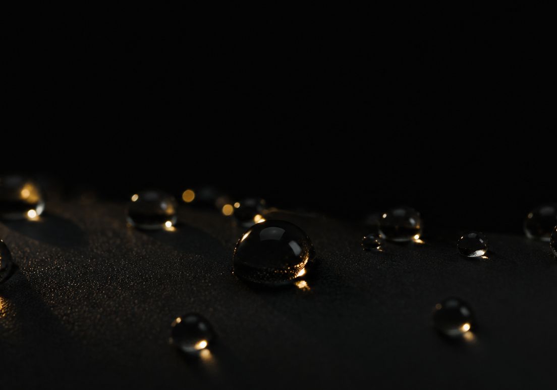 Water beading into spheres on a coated dark surface instead of spreading